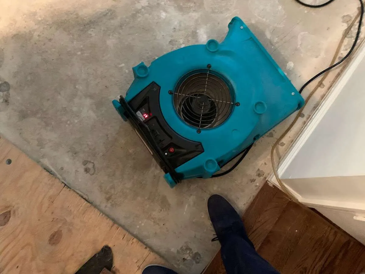 Air mover drying subfloor during Commercial Water Damage Restoration in Merrimac